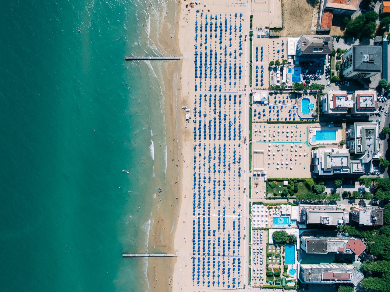 Letecký pohľad na pláž s radmi slnečníkov v Lido di Jesolo